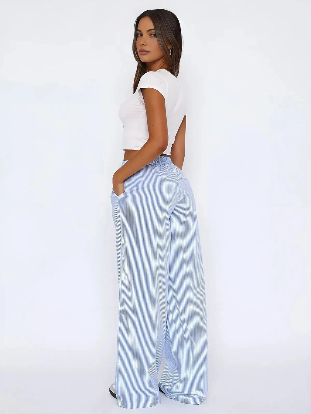 Women's blue striped wide-leg pants featuring an elastic waist, made from soft fabric for comfort and ease of movement.