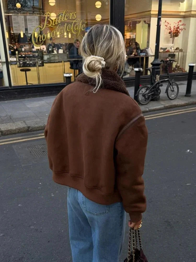 Women's brown aviator jacket featuring a faux shearling collar, zip closure, and side pockets for a casual, stylish look.