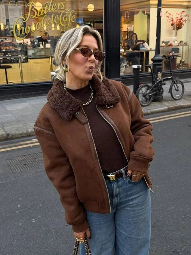 Women's brown aviator jacket featuring a faux shearling collar, crafted from soft leather for warmth and style.