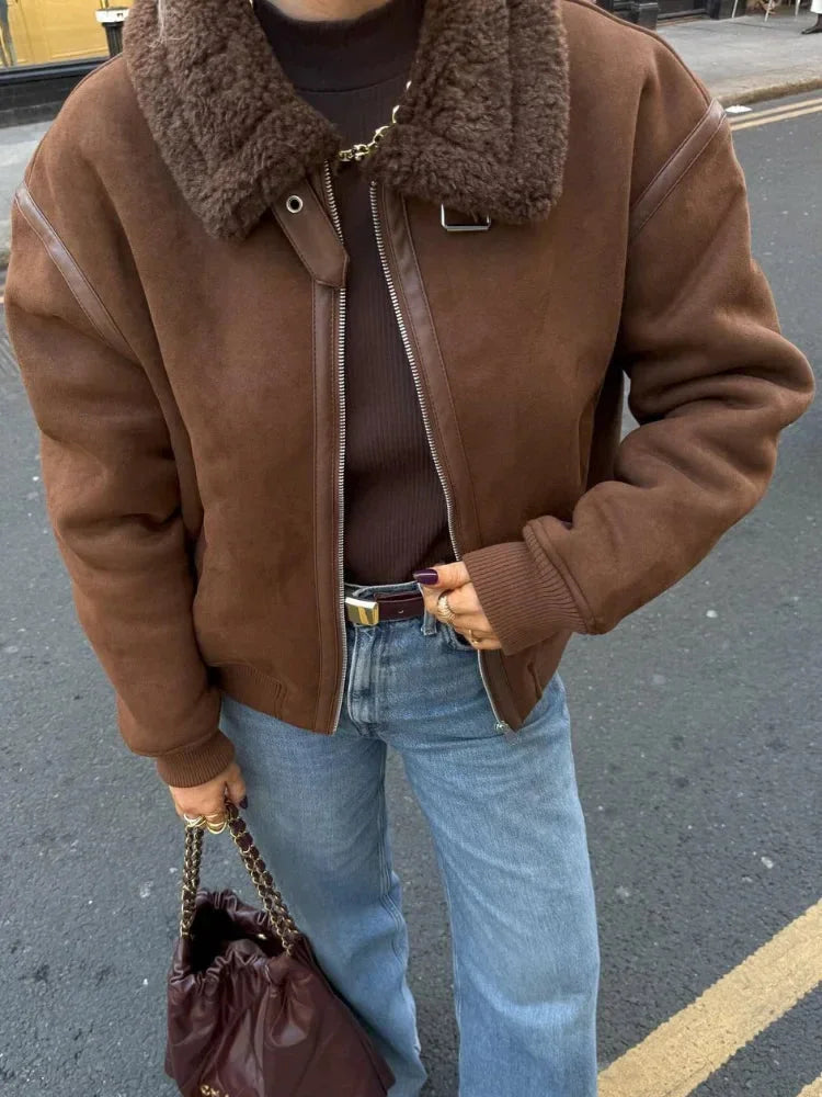 Women's brown aviator jacket made of durable material featuring a faux shearling collar and classic aviator design.