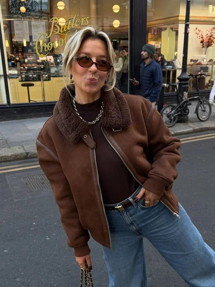 Women's brown aviator jacket featuring a faux shearling collar and soft leather-like material for a classic, stylish look.
