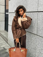 Women's brown belted coat featuring a plush shearling collar, crafted from warm fabric for comfort and style.