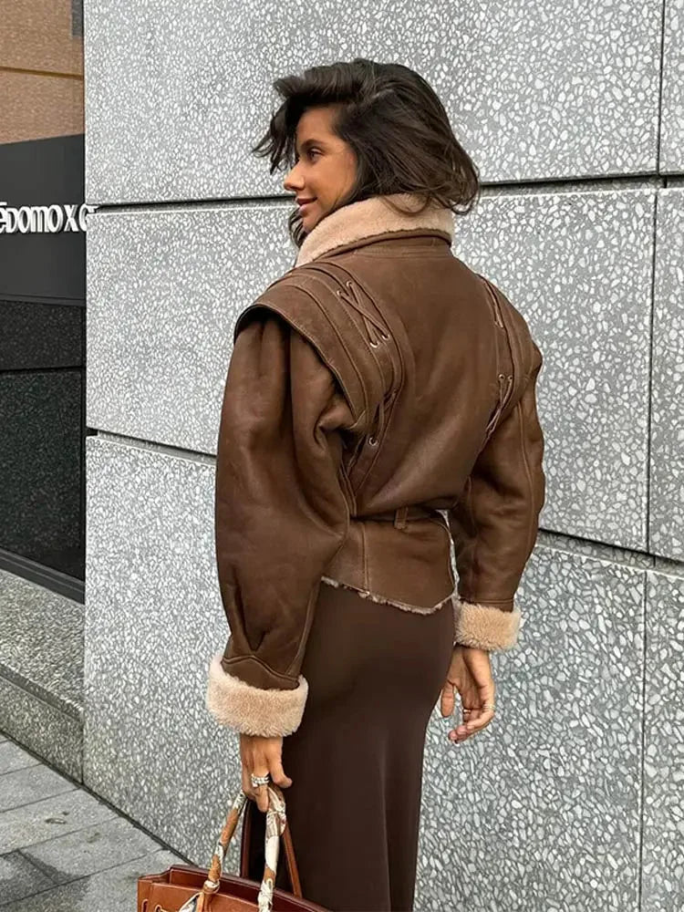 Women's brown belted coat with a shearling collar, featuring a warm fabric, tailored fit, and stylish design for cold…