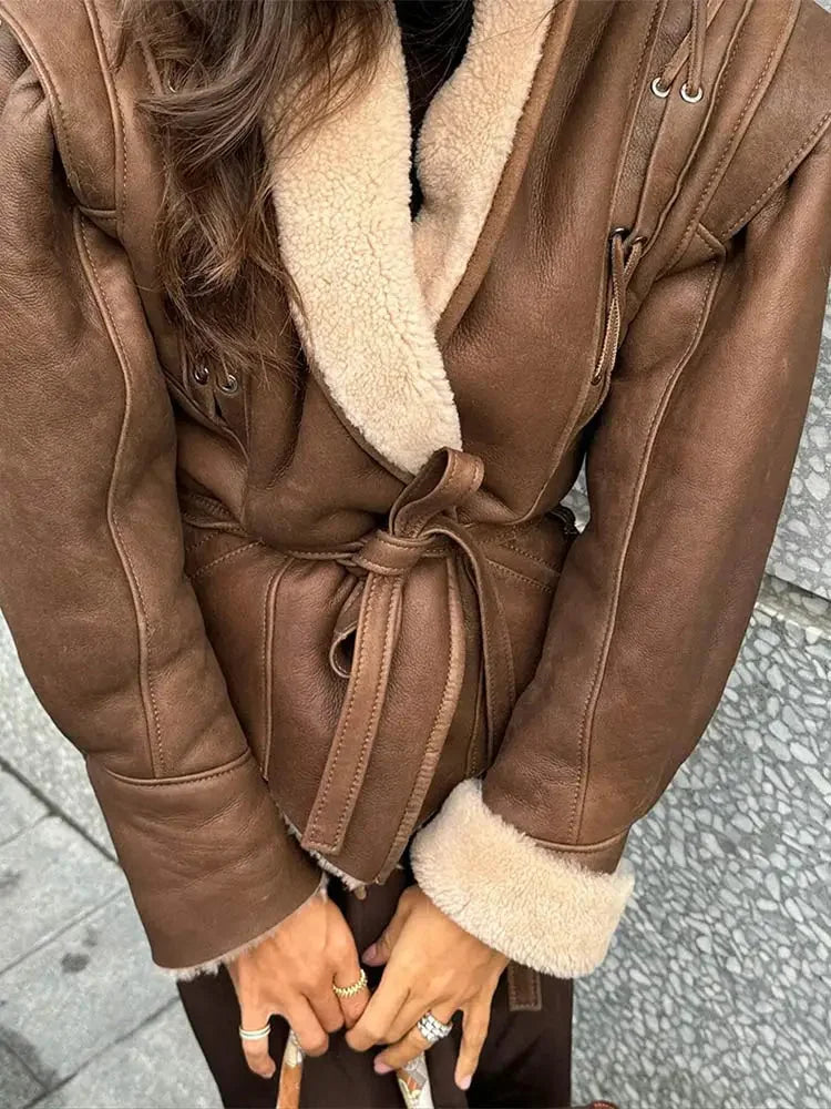 Women’s brown belted coat with a shearling collar, featuring a stylish design and made from warm, soft fabric.