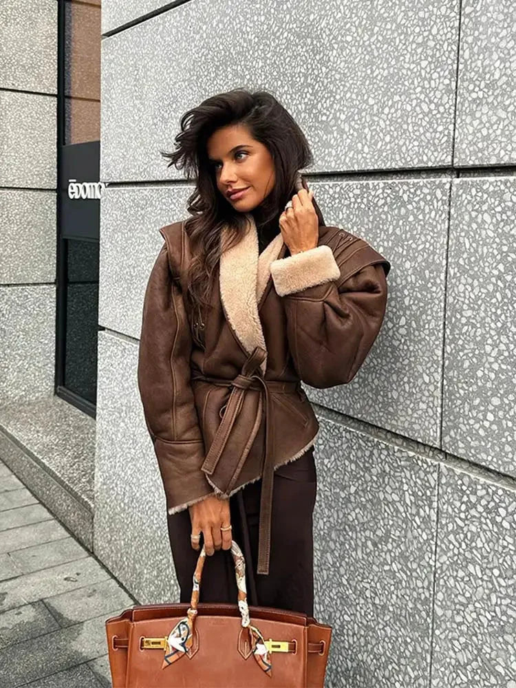Women's brown coat with a belted waist and shearling collar, made from warm fabric for comfort in chilly weather.