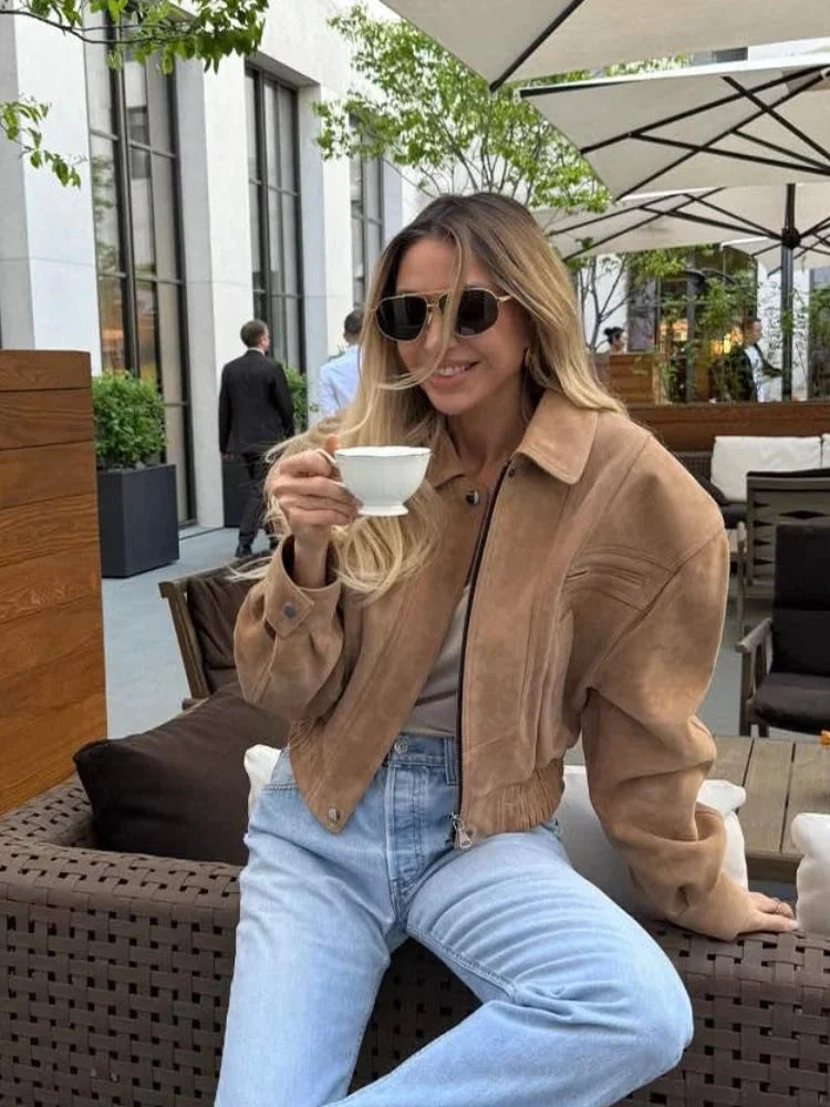 Women's brown cropped suede jacket featuring a zip closure and functional pockets for a stylish, casual look.
