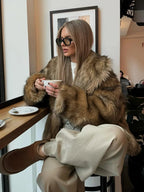 Women's brown faux fur jacket featuring long sleeves and a cozy, textured design for warmth and style.