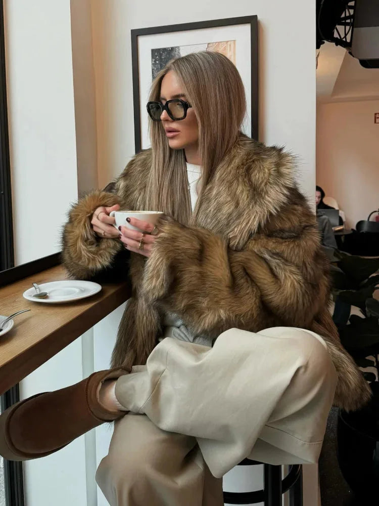 Women's brown faux fur jacket featuring long sleeves and a cozy, textured design for warmth and style.