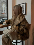 Women's brown faux fur jacket with long sleeves, featuring a soft texture and cozy warmth for casual wear.