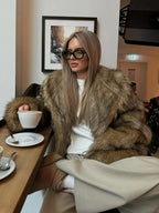 Women's brown faux fur jacket with long sleeves, featuring a soft texture and cozy style for casual wear.