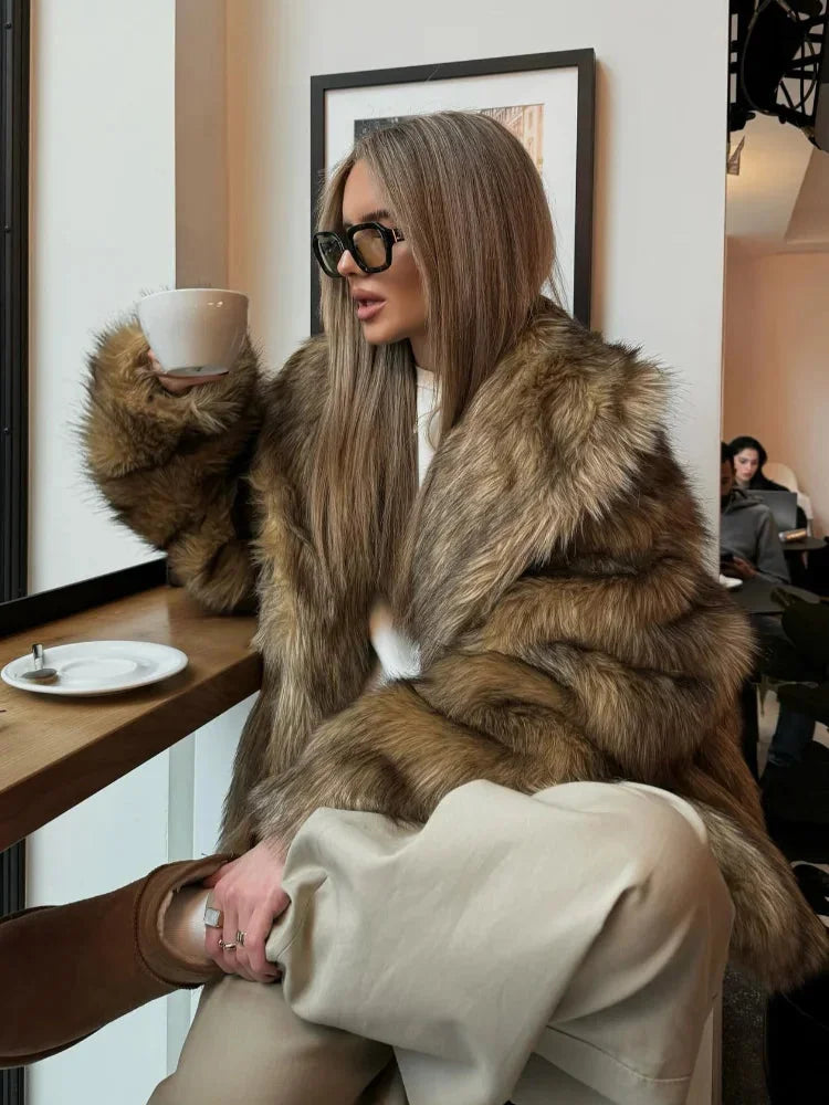 Women's brown faux fur jacket with long sleeves, featuring a soft texture and cozy design for warmth and style.