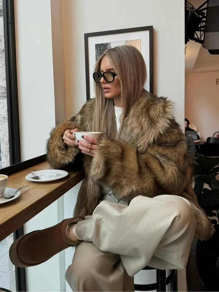 Women's brown faux fur jacket with long sleeves, featuring a soft texture and stylish design for warmth and comfort.