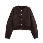 Women's brown knit cardigan featuring long sleeves, functional pockets, and a cozy design, perfect for layering.