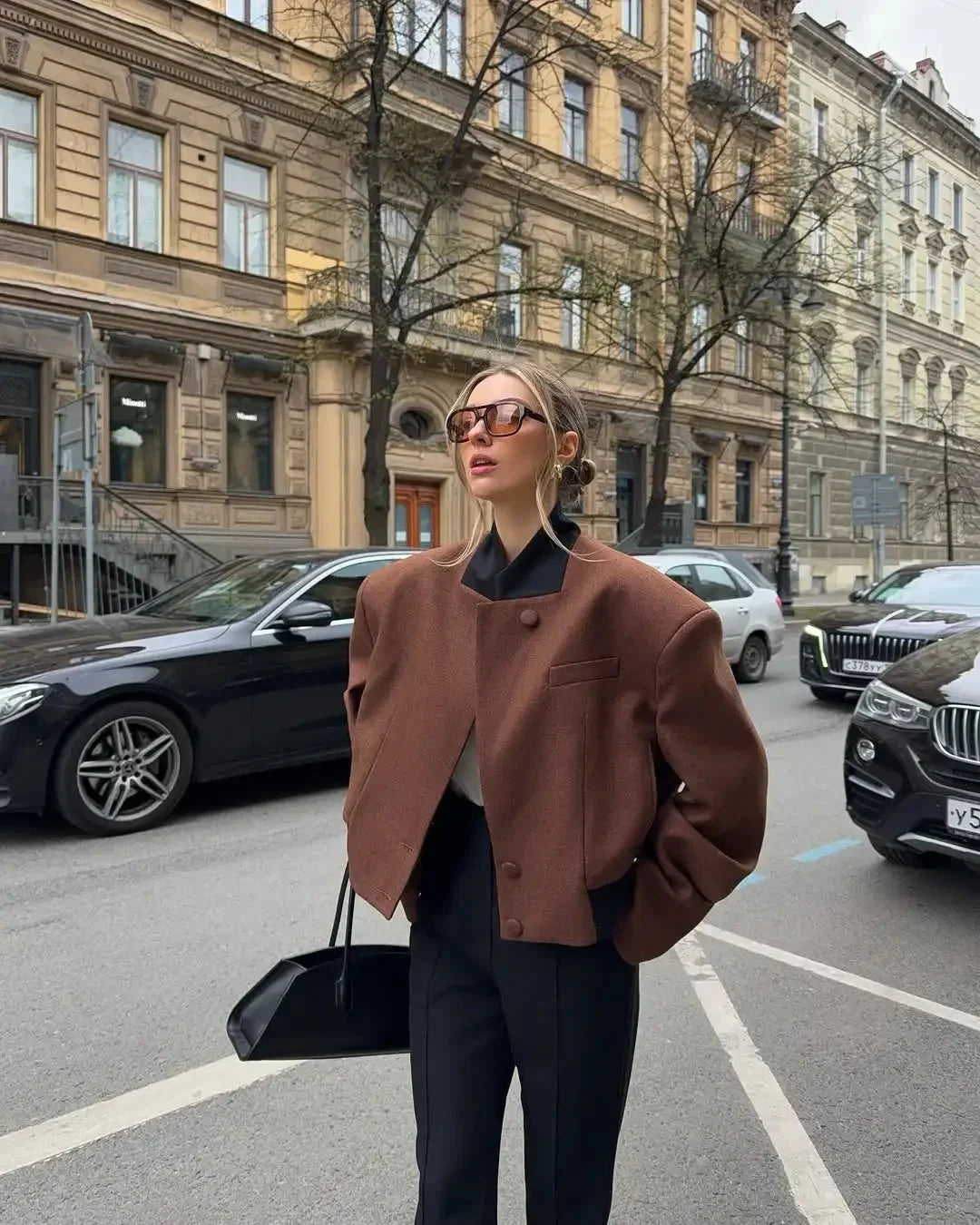 Women's brown lapel neck jacket made of soft fabric with side pockets and a tailored fit for a stylish look.