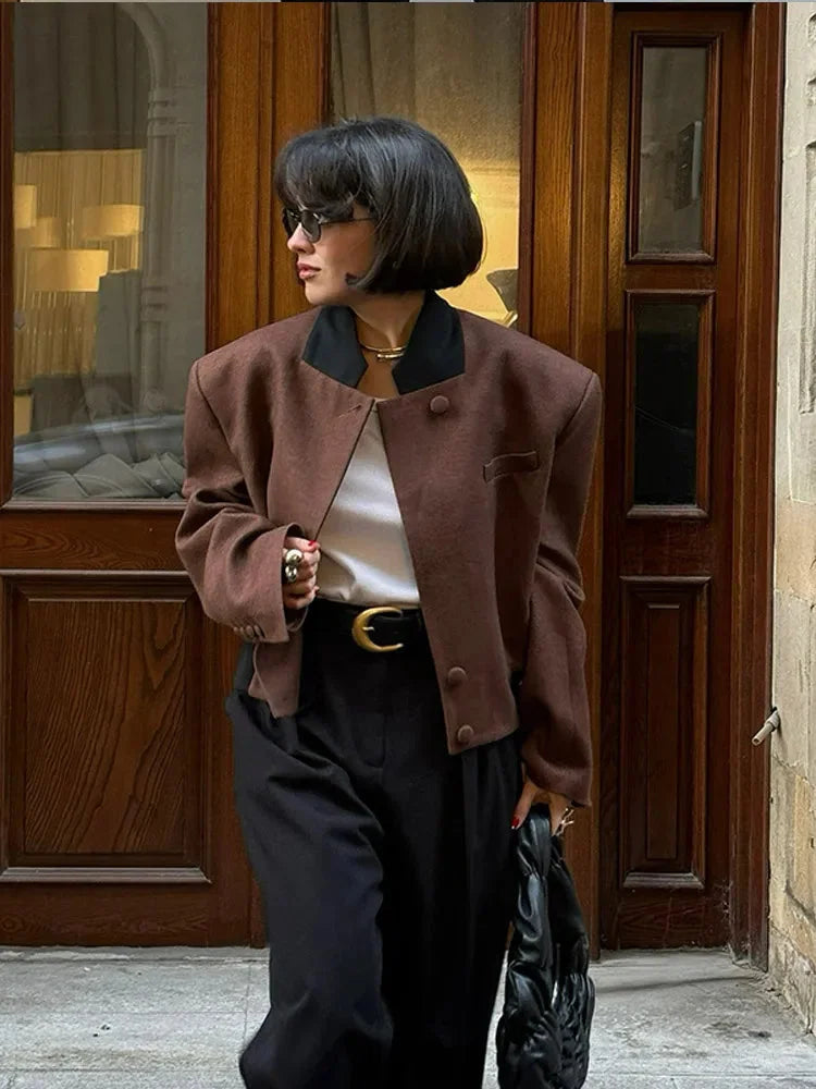 Women's brown lapel neck jacket made of durable fabric, featuring practical pockets and a classic design for everyday wear.
