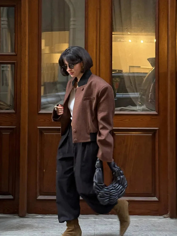 Women's brown lapel neck jacket made of soft fabric, featuring two front pockets and a tailored fit for everyday wear.