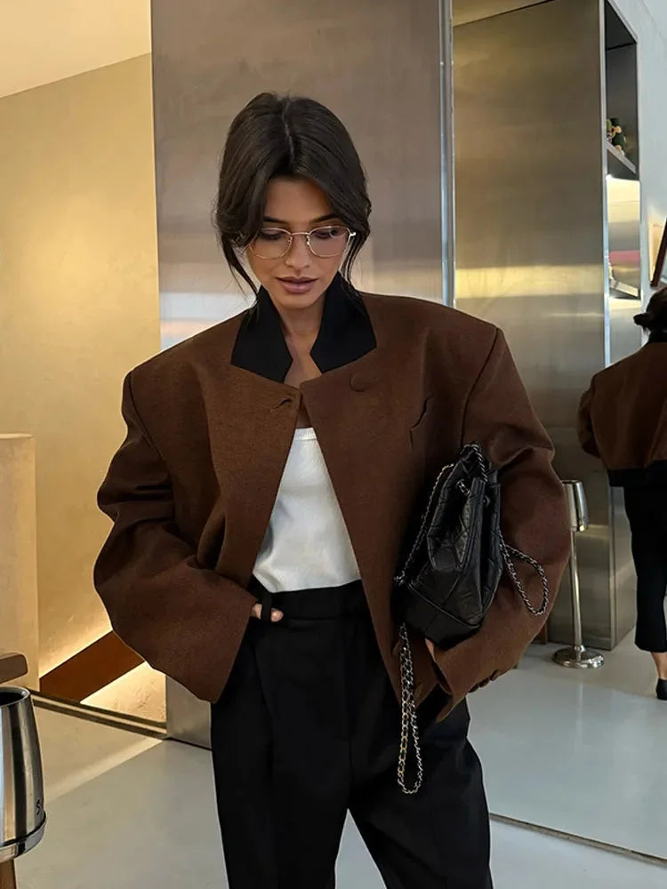 Women's brown lapel neck jacket with pockets, made of soft fabric featuring a classic design and tailored fit.
