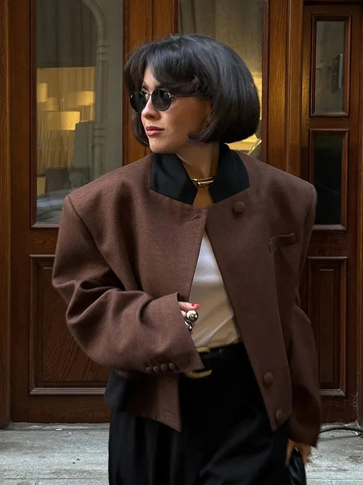 Women's brown lapel neck jacket made of durable fabric, featuring side pockets and a classic tailored fit.