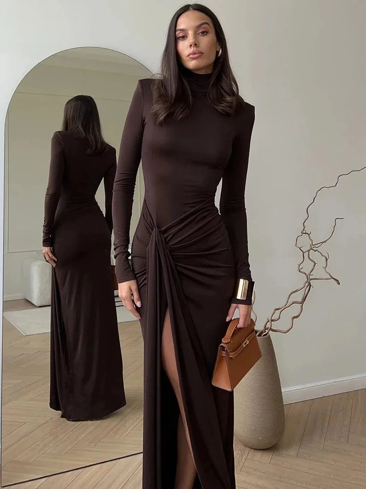 Women's brown ruched maxi dress with turtleneck, made from soft fabric, featuring a flattering silhouette and elegant drape.