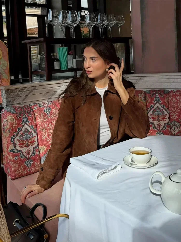 Women's brown suede-look short jacket with a collared design and soft texture, perfect for casual or layered outfits.