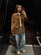 Women's brown suede-look short jacket with a collared design and front pockets, perfect for casual layering.