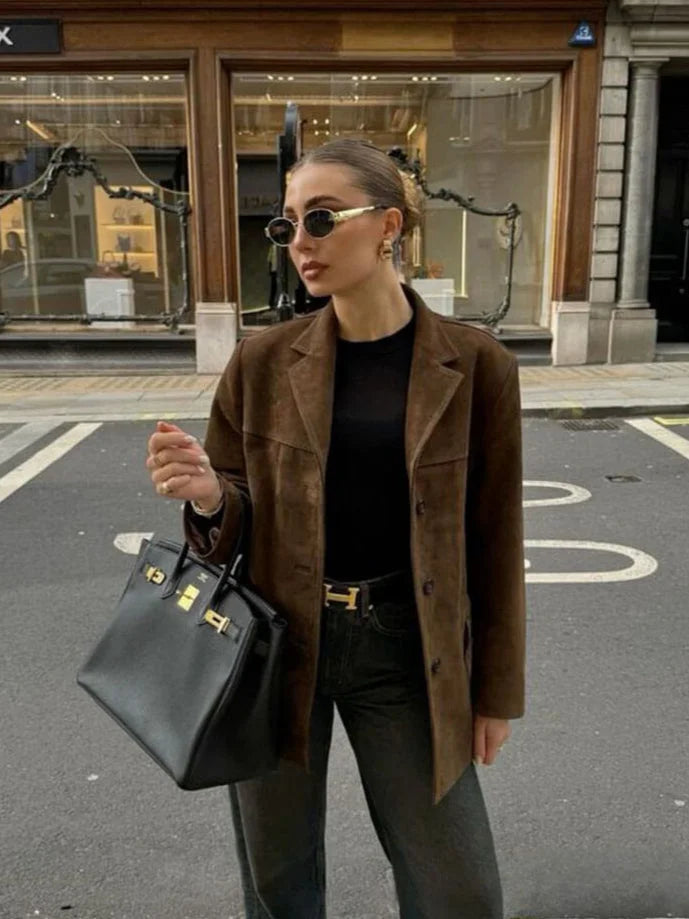 Women's brown suede-like jacket featuring a button-up front and a classic design, perfect for layering in cooler weather.