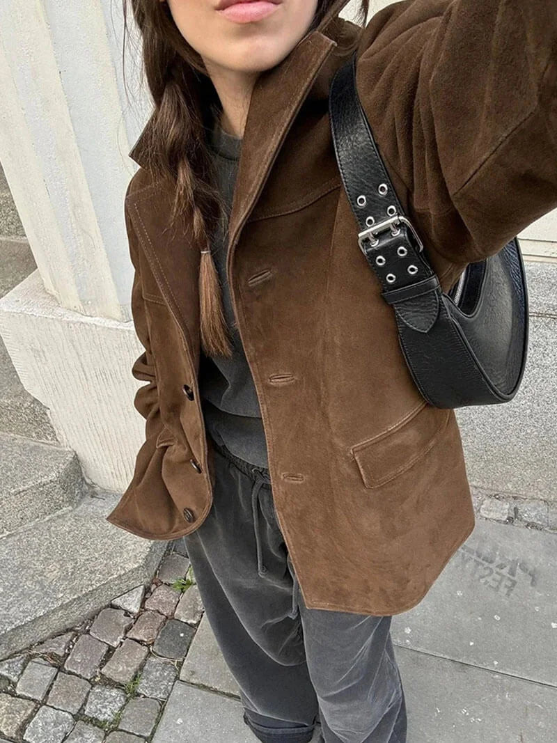 Women's brown suede-look jacket featuring a button-up front and stylish textured finish for a cozy look.