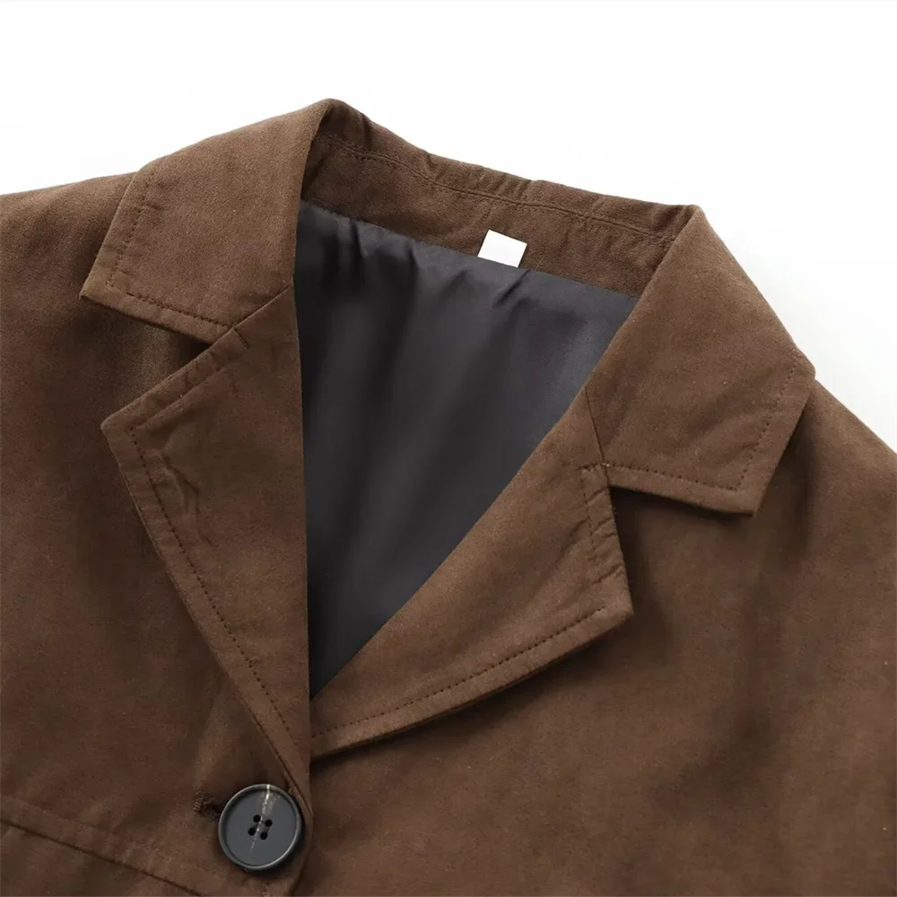 Women's brown suede slim fit short jacket featuring a tailored design with a stylish collar and subtle stitching details.