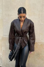 Women's brown tie-waist jacket featuring a structured design, made from soft fabric with elegant tailoring and versatile…