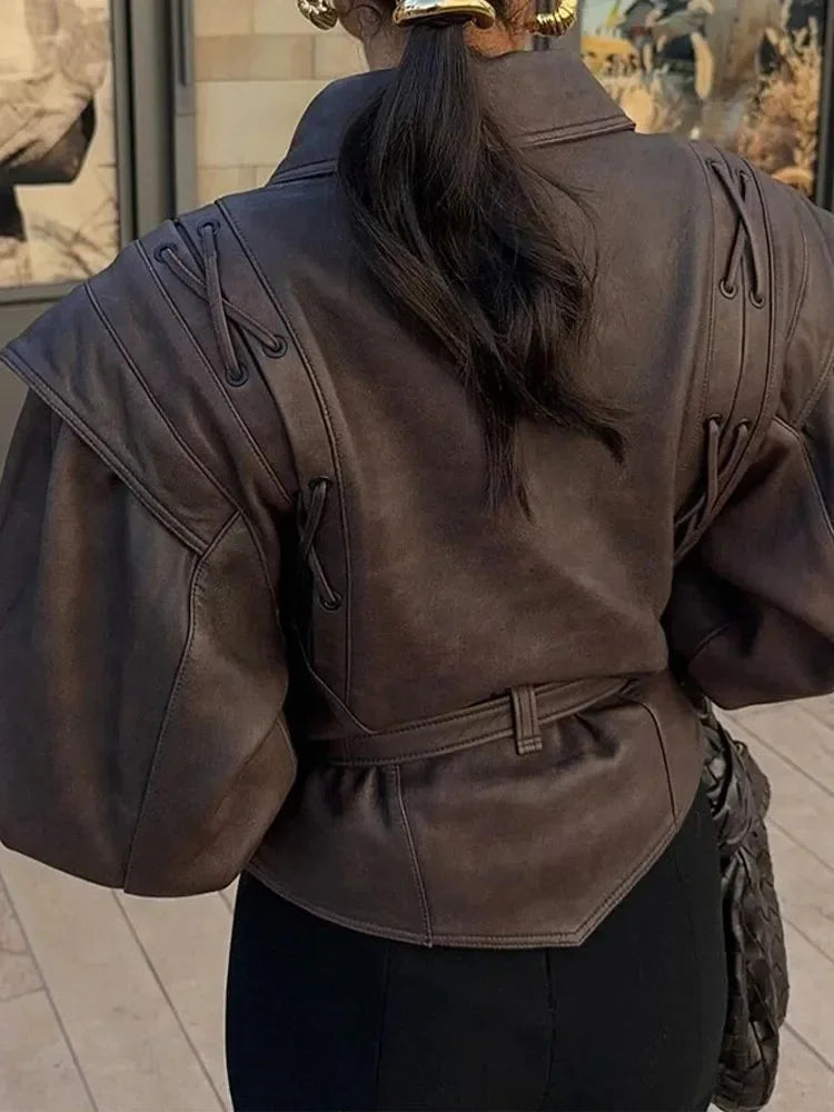 Women's brown tie-waist jacket featuring a structured design, crafted from soft fabric for a tailored fit and modern…