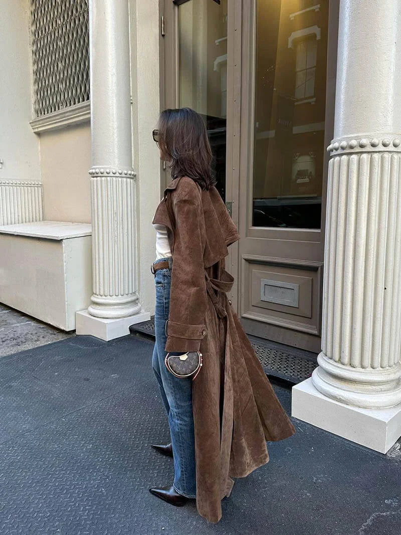 Women's brown trench coat with belt and lapels, crafted from durable cotton twill for a stylish and timeless look.