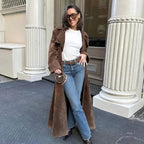 Women's brown trench coat featuring wide lapels, a tie waist, and a sleek silhouette in breathable fabric for comfort.