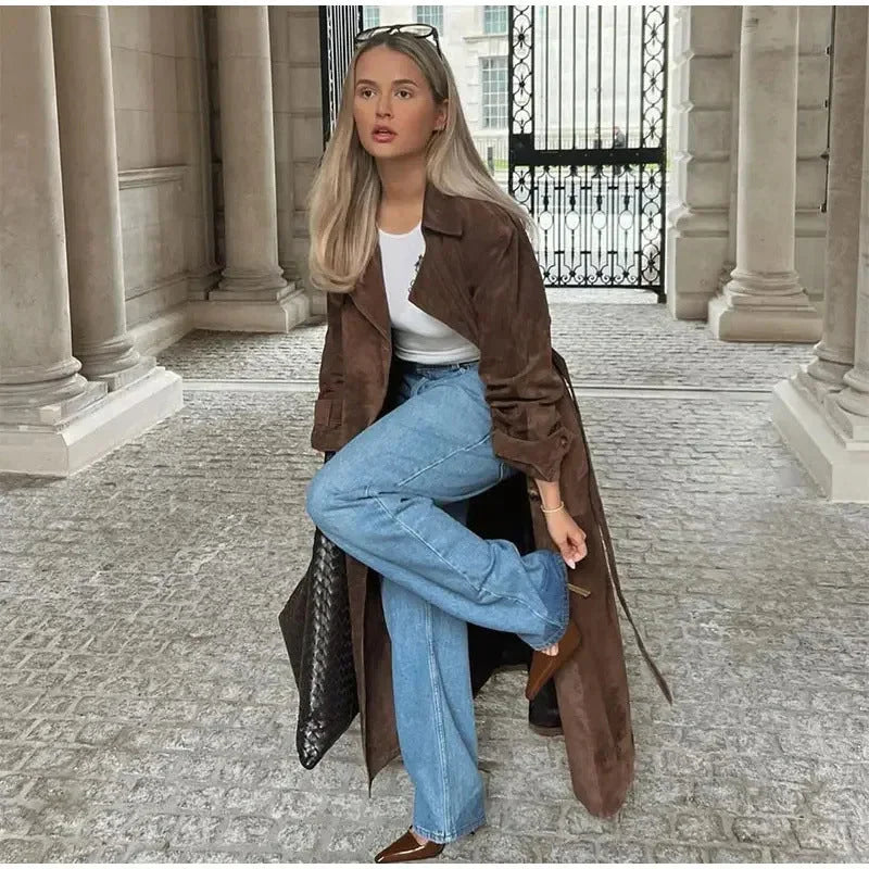 Women's brown trench coat featuring wide lapels, a tie waist, and made from soft, durable fabric for stylish layering.