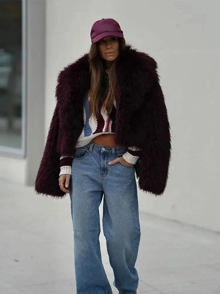 Women's burgundy faux fur coat featuring an oversized collar and soft texture, perfect for stylish warmth in colder weather.