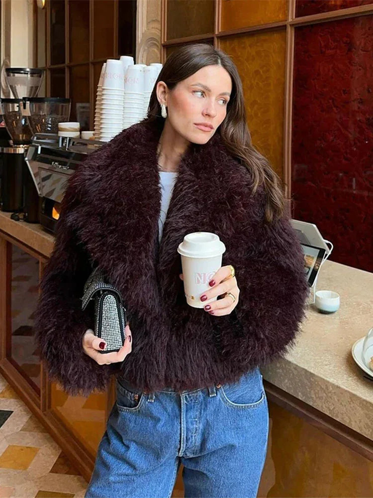 Women's burgundy faux fur coat featuring an oversized collar, soft texture, and elegant design for a stylish look.