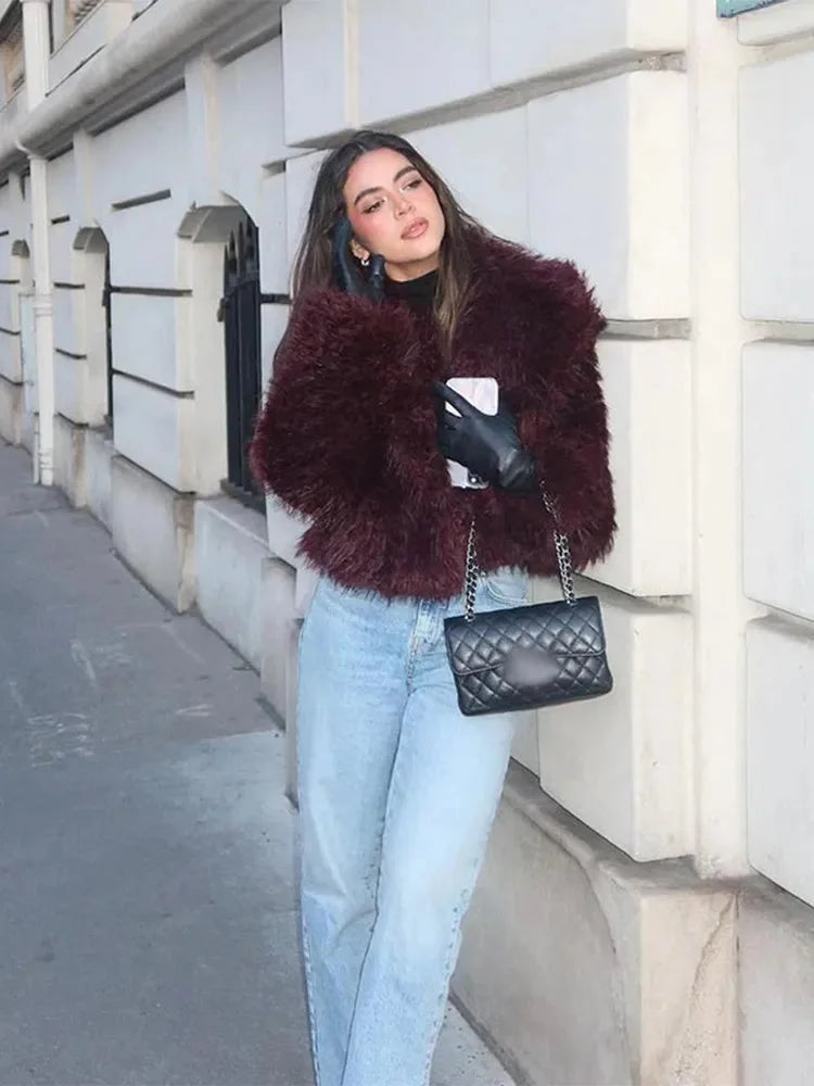 Women's burgundy faux fur coat featuring an oversized collar, soft texture, and stylish design for warmth and comfort.