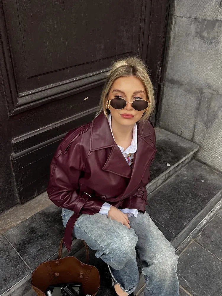 Women's burgundy short belted trench coat made of durable cotton blend, featuring a classic design and stylish waist tie.