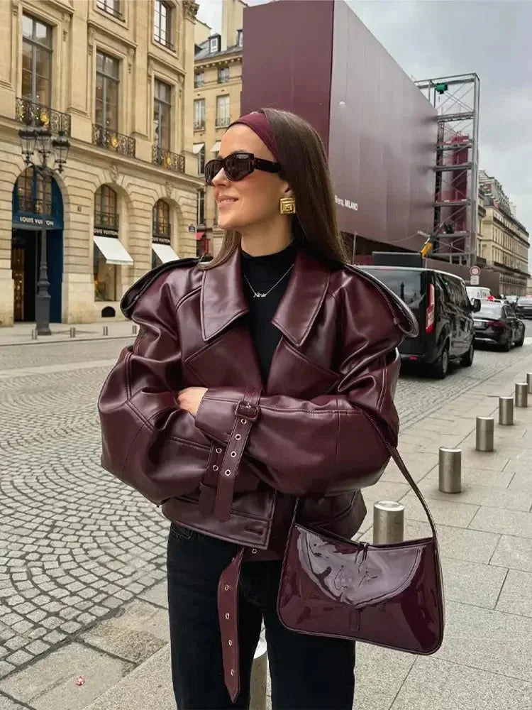 Women's burgundy short belted trench coat made from cotton blend; features classic design and stylish waist belt for a…