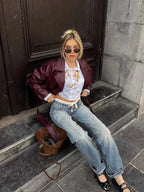 Women's burgundy short belted trench coat made of lightweight fabric with a classic double-breasted design and waist tie.