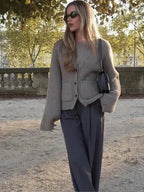 Women's button-front cardigan with wide sleeves, made of soft knit fabric, featuring a relaxed fit and ribbed cuffs for…