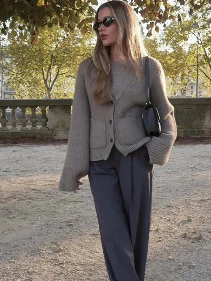 Women's button-front cardigan with wide sleeves, made of soft knit fabric, featuring a relaxed fit and ribbed cuffs for…