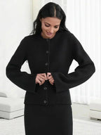 Women's long-sleeve button-up cardigan made from soft cotton, featuring a relaxed fit and classic V-neck design.