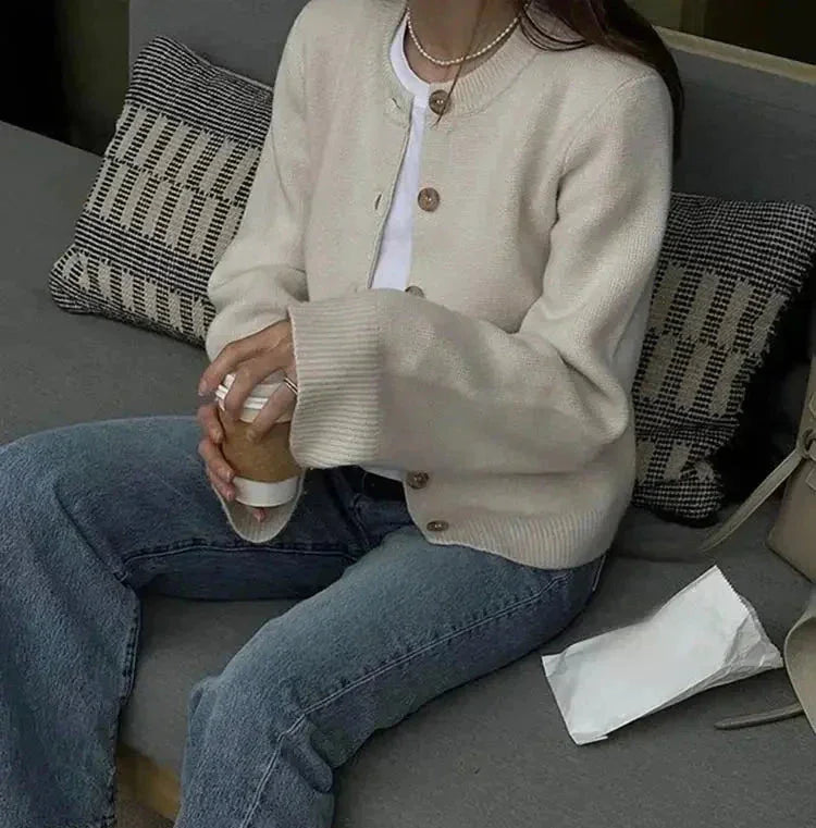 Women's button-up cardigan in soft cotton, featuring long sleeves and a classic design, ideal for layering in cool weather.