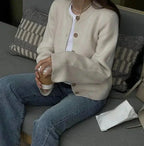 Women's button-up cardigan in soft cotton, featuring long sleeves and a classic design, ideal for layering in cool weather.