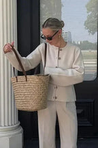 Women's button-up cardigan with long sleeves, made from soft cotton blend, featuring ribbed cuffs and a relaxed fit.