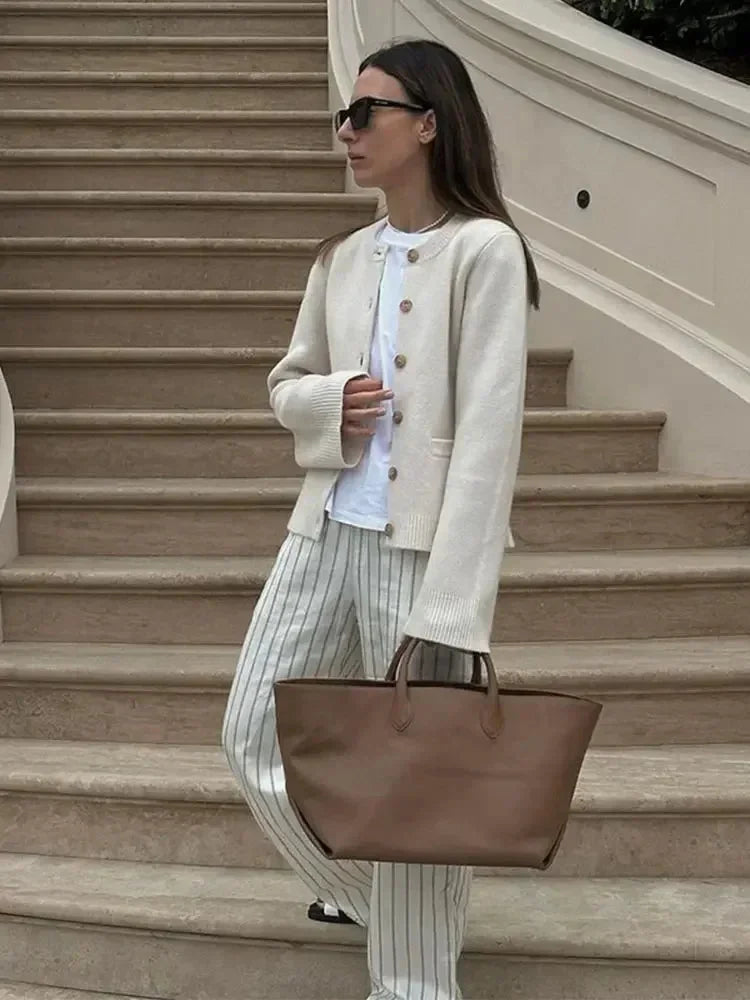 Women's long-sleeve button-up cardigan in soft knit fabric with a relaxed fit and classic design, perfect for layering.