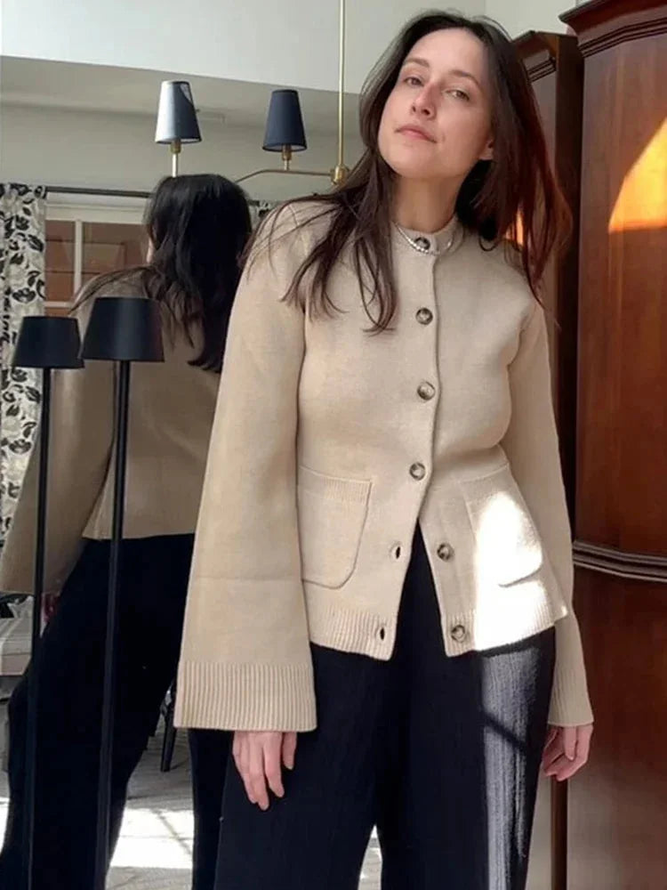 Women's long sleeve button-up cardigan in soft knit fabric, featuring a classic design and ribbed cuffs for a comfortable…