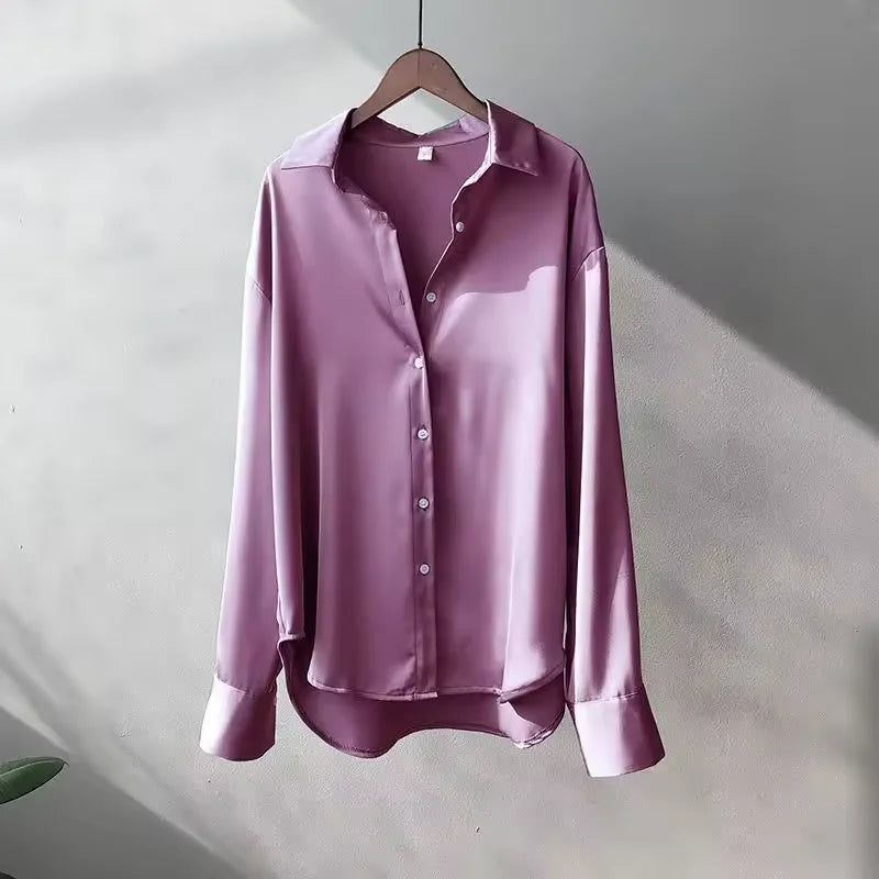 Women's button-up loose-fit blouse with long sleeves, made from lightweight cotton, featuring a relaxed design and classic…