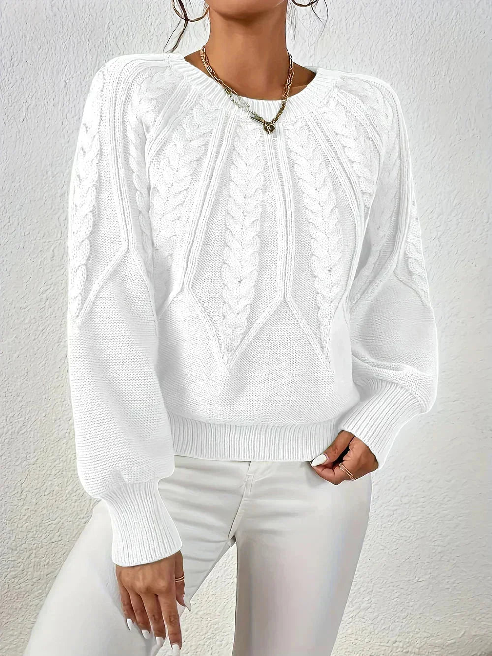 Women's cable-knit sweater featuring a textured pattern, crafted from soft, warm fabric, perfect for cool weather layering.
