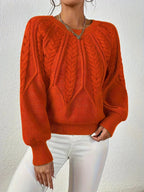 Women's cable-knit sweater featuring a textured pattern, crafted from soft, cozy fabric for warmth and comfort.